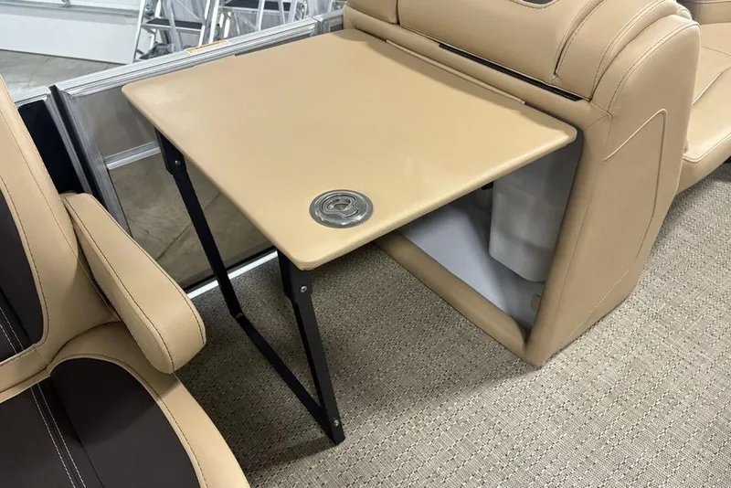 Slide: The Image of 2025 Barletta C22QC boat interior with beige seating and foldable table. - 10
