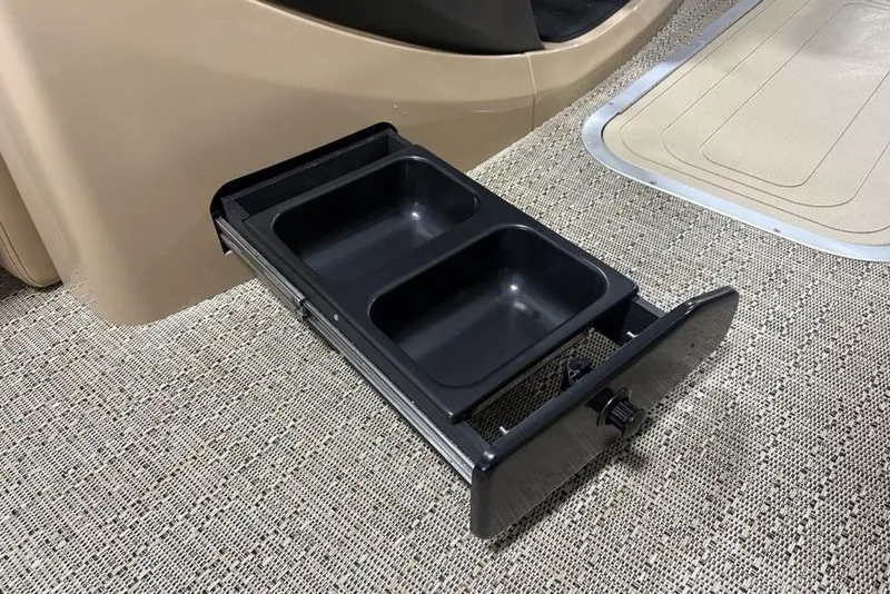 Slide: The Image of Barletta C22QC 2025 boat interior with pull-out storage tray on carpeted floor. - 14