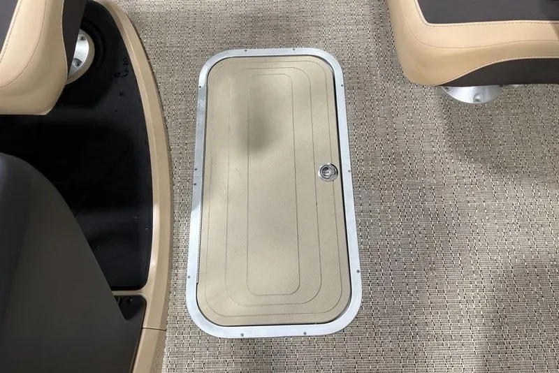 Slide: The Image of 2025 Barletta C22QC boat interior with beige flooring and storage compartment. - 17