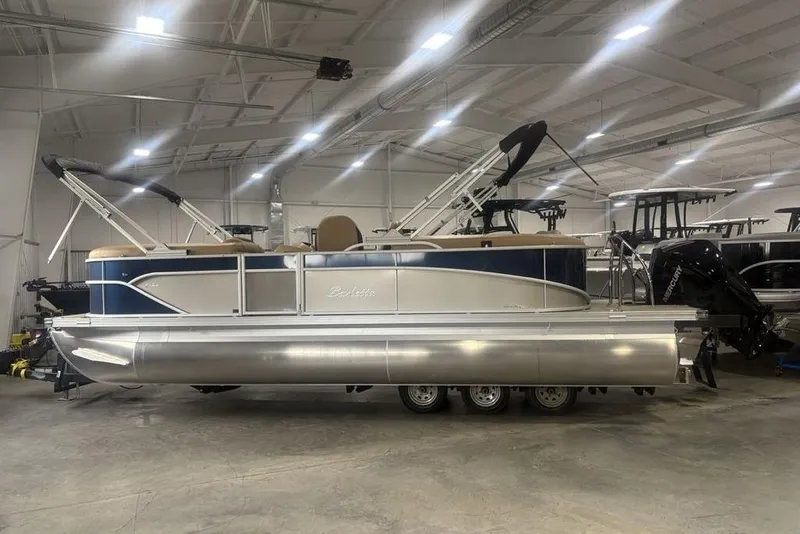 The Image of 2025 Barletta C22QC pontoon boat in a showroom, featuring sleek design and modern amenities. - 2
