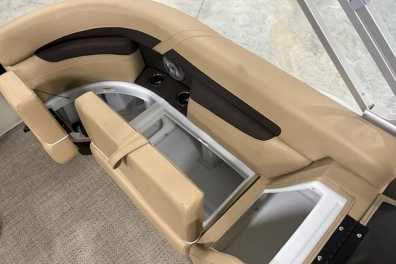 Slide: The Image of 2025 Barletta C22QC boat interior with tan seating and storage compartments. - 21