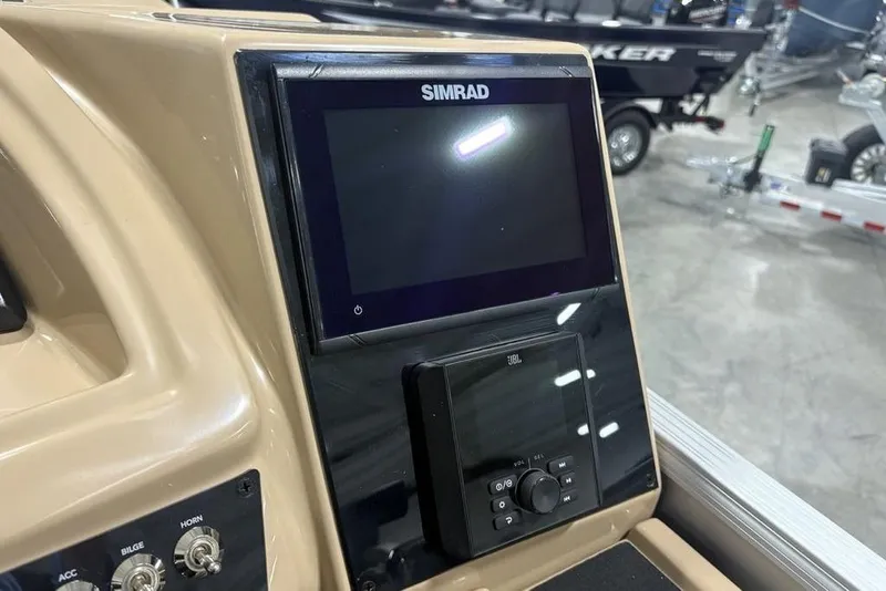 Slide: The Image of Control panel of 2025 Barletta C22QC boat featuring Simrad and JBL systems. - 22