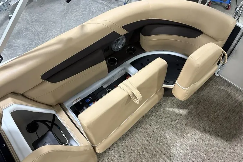 Slide: The Image of 2025 Barletta C22QC boat interior with tan seating and storage compartments. - 29