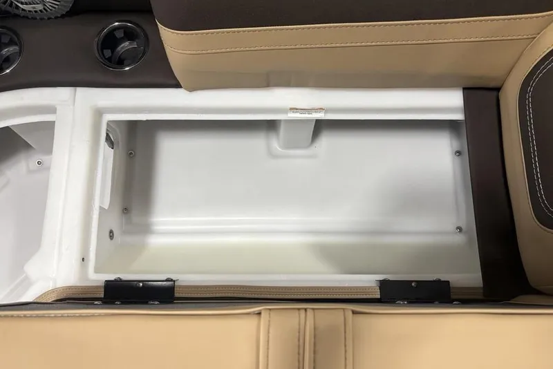 Slide: The Image of 2025 Barletta C22QC boat storage compartment with beige and brown seating. - 9