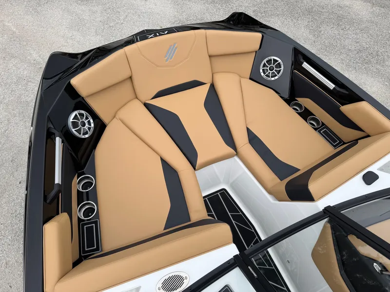 Slide: The Image of 2025 ATX Surf Boats 20 Type-S interior with tan and black seating, cup holders, and speakers. - 10