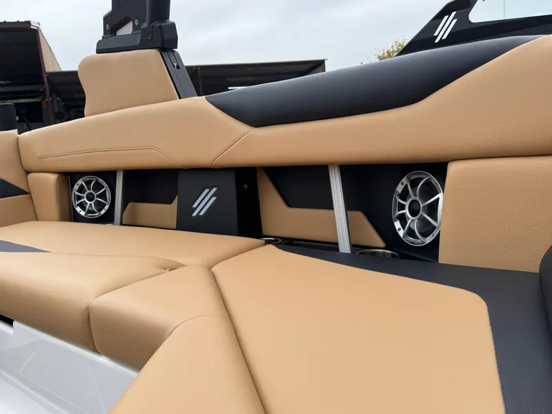 Slide: The Image of 2025 ATX Surf Boats 20 Type-S interior with tan and black seating, featuring built-in speakers. - 11
