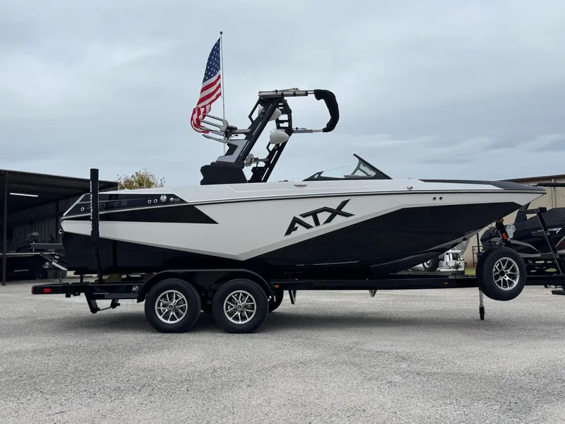 Slide: The Image of 2025 ATX Surf Boats 20 Type-S on trailer with American flag. - 2