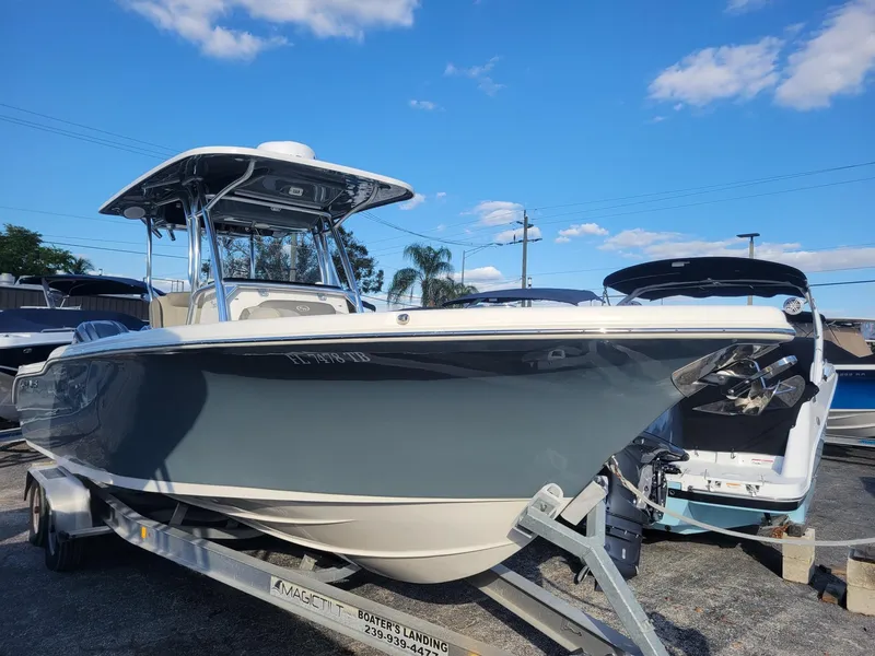 The Image of 2022 Key West 263 FS boat on trailer under clear blue sky. - 0