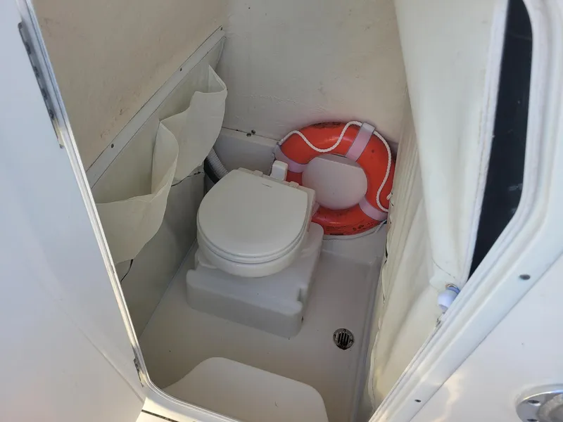 Slide: The Image of 2022 Key West 263 FS boat interior with toilet and life preserver. - 15