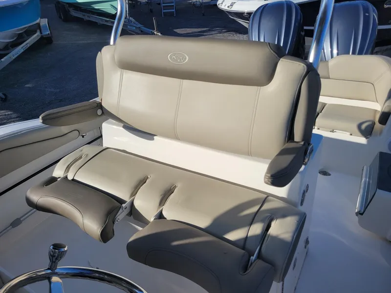Slide: The Image of 2022 Key West 263 FS boat seating with beige upholstery and steering wheel. - 16