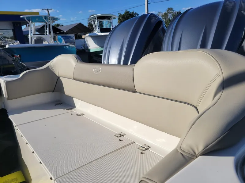 Slide: The Image of 2022 Key West 263 FS boat interior with beige seating and dual engines. - 6