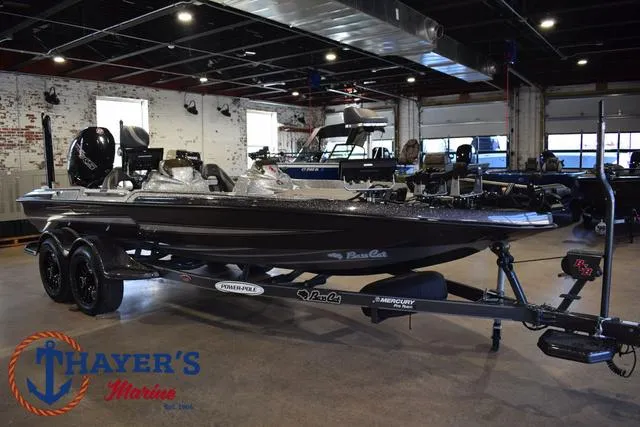 Slide: The Image of 2023 Bass Cat Puma STS boat displayed at Thayer's Marine showroom. - 1