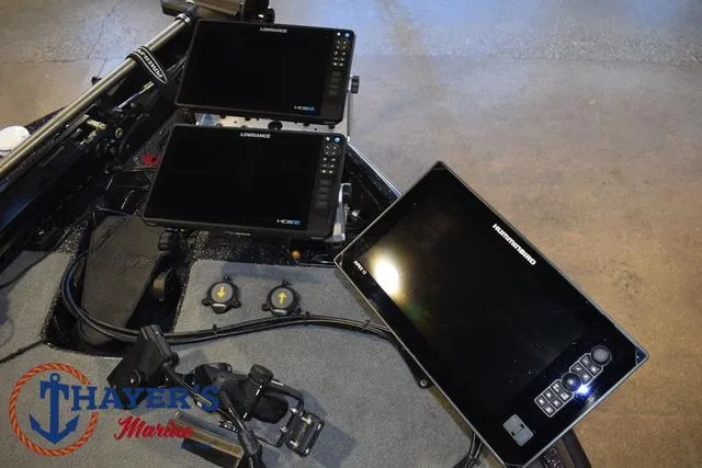 Slide: The Image of 2023 Bass Cat Puma STS dashboard with multiple Lowrance fish finders. - 11