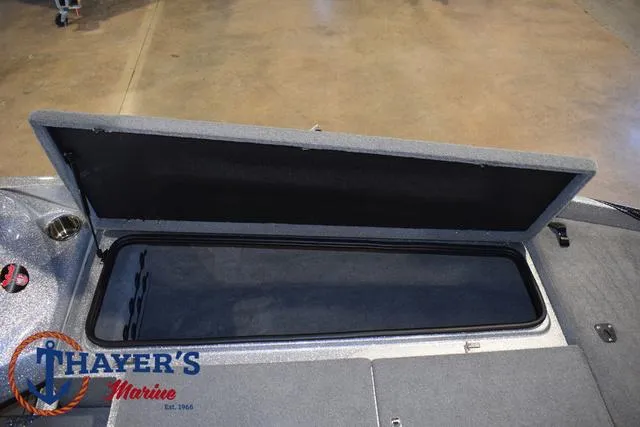 Slide: The Image of 2023 Bass Cat Puma STS storage compartment, open lid, Thayer's Marine logo visible. - 14