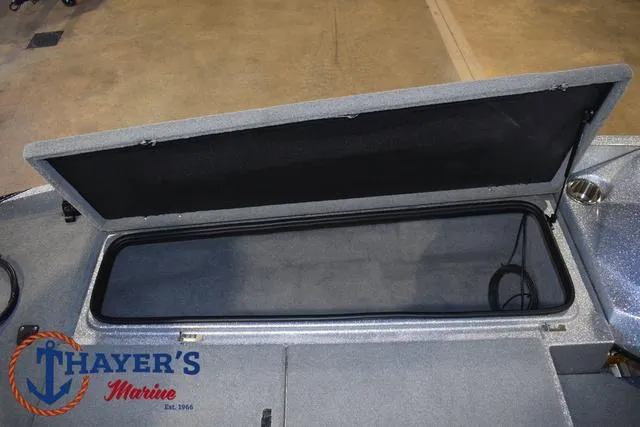 Slide: The Image of 2023 Bass Cat Puma STS boat storage compartment open at Thayer's Marine. - 16