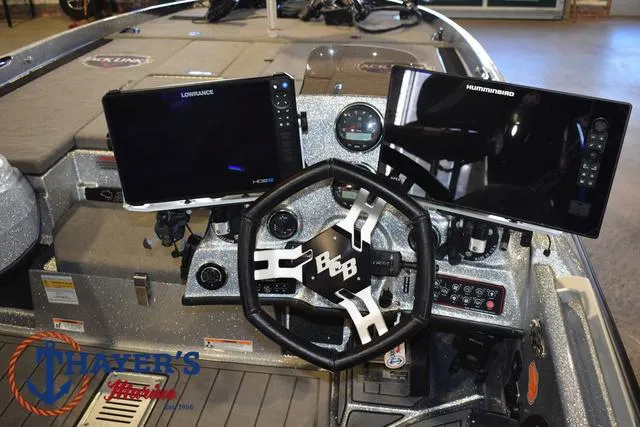 Slide: The Image of 2023 Bass Cat Puma STS boat dashboard with dual fish finders and steering wheel. - 19