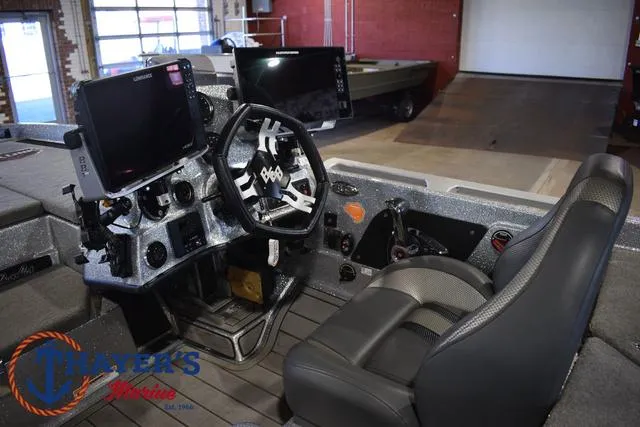 Slide: The Image of 2023 Bass Cat Puma STS boat interior with modern dashboard and seating. - 21