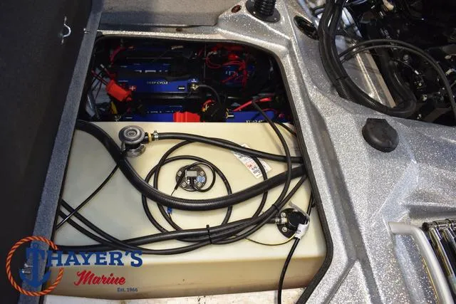 Slide: The Image of 2023 Bass Cat Puma STS boat battery compartment with wiring and Thayer's Marine logo. - 28