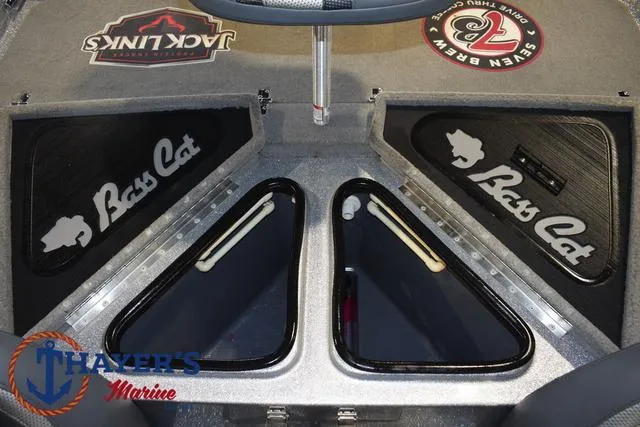 Slide: The Image of 2023 Bass Cat Puma STS boat interior with storage compartments and logos. - 30