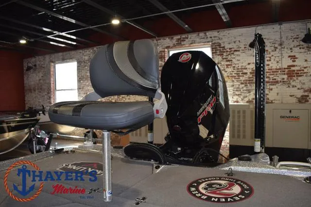 Slide: The Image of 2023 Bass Cat Puma STS boat interior with seat and motor, displayed at Thayer's Marine. - 31