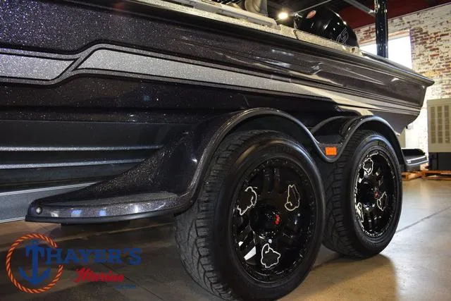 Slide: The Image of 2023 Bass Cat Puma STS boat trailer with black wheels in showroom. - 35