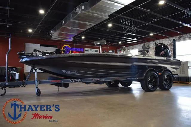 Slide: The Image of 2023 Bass Cat Puma STS boat displayed indoors at Thayer's Marine showroom. - 36