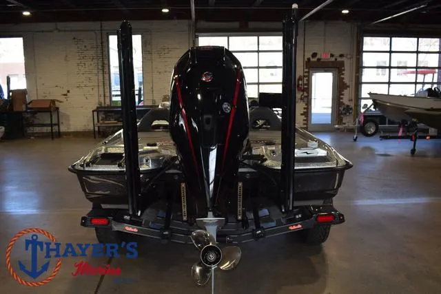 Slide: The Image of 2023 Bass Cat Puma STS boat in showroom, rear view with motor and logo. - 39