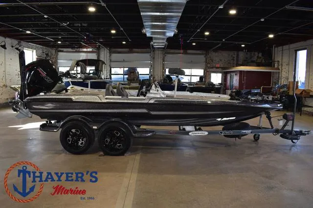 Slide: The Image of 2023 Bass Cat Puma STS boat displayed indoors at Thayer's Marine showroom. - 41