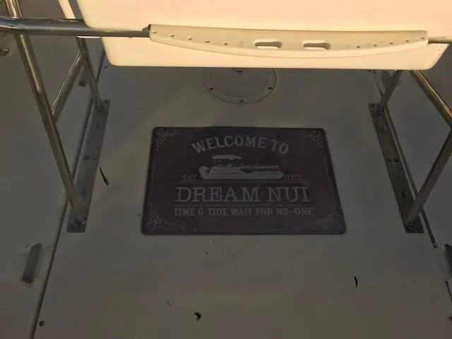 Slide: The Image of Boston Whaler 260 Outrage 1998 boat deck with "Dream Nui" welcome mat. - 15