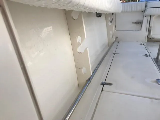 Slide: The Image of Interior view of a 1998 Boston Whaler 260 Outrage boat, showcasing seating and storage. - 23