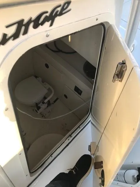 Slide: The Image of 1998 Boston Whaler 260 Outrage boat interior with open hatch and visible toilet. - 29