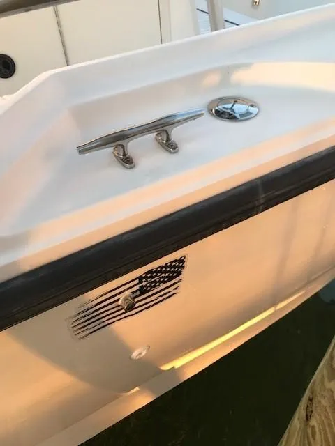 Slide: The Image of 1998 Boston Whaler 260 Outrage boat with American flag decal and cleat. - 36