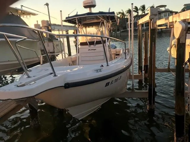 Slide: The Image of 1998 Boston Whaler 260 Outrage boat docked at marina during sunset. - 4