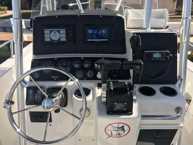 Slide: The Image of 1998 Boston Whaler 260 Outrage boat dashboard with steering wheel and navigation equipment. - 9