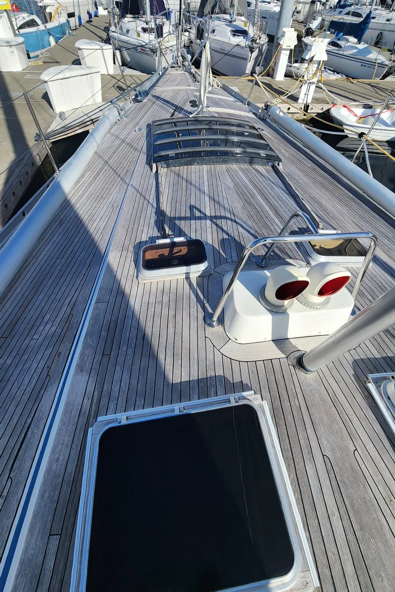 Slide: The Image of Deck of 1983 Nautor Swan 651 yacht with wooden finish and hatches. - 13