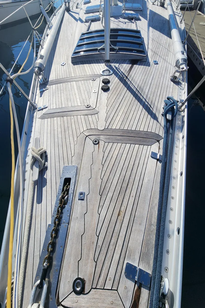 Slide: The Image of Deck of 1983 Nautor Swan 651 yacht with wooden finish and sleek design. - 18