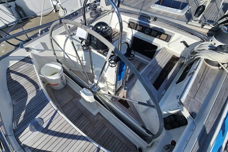 Slide: The Image of Cockpit of 1983 Nautor Swan 651 sailboat with steering wheel and wooden deck. - 24