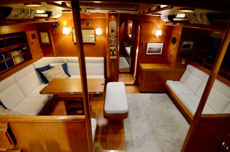 Slide: The Image of Luxurious 1983 Nautor Swan 651 yacht interior with elegant wood finish and cozy seating area. - 26