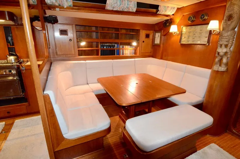 Slide: The Image of Luxurious 1983 Nautor Swan 651 yacht interior with cozy dining area and elegant wood finish. - 27