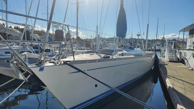 Slide: The Image of 1983 Nautor Swan 651 yacht docked in a sunny marina. - 3