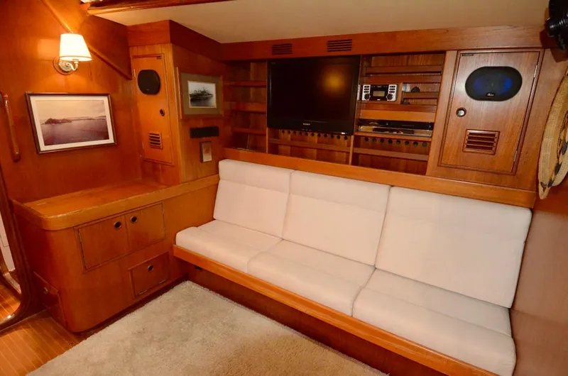 Slide: The Image of Luxurious 1983 Nautor Swan 651 yacht interior with white sofa and wooden cabinetry. - 30