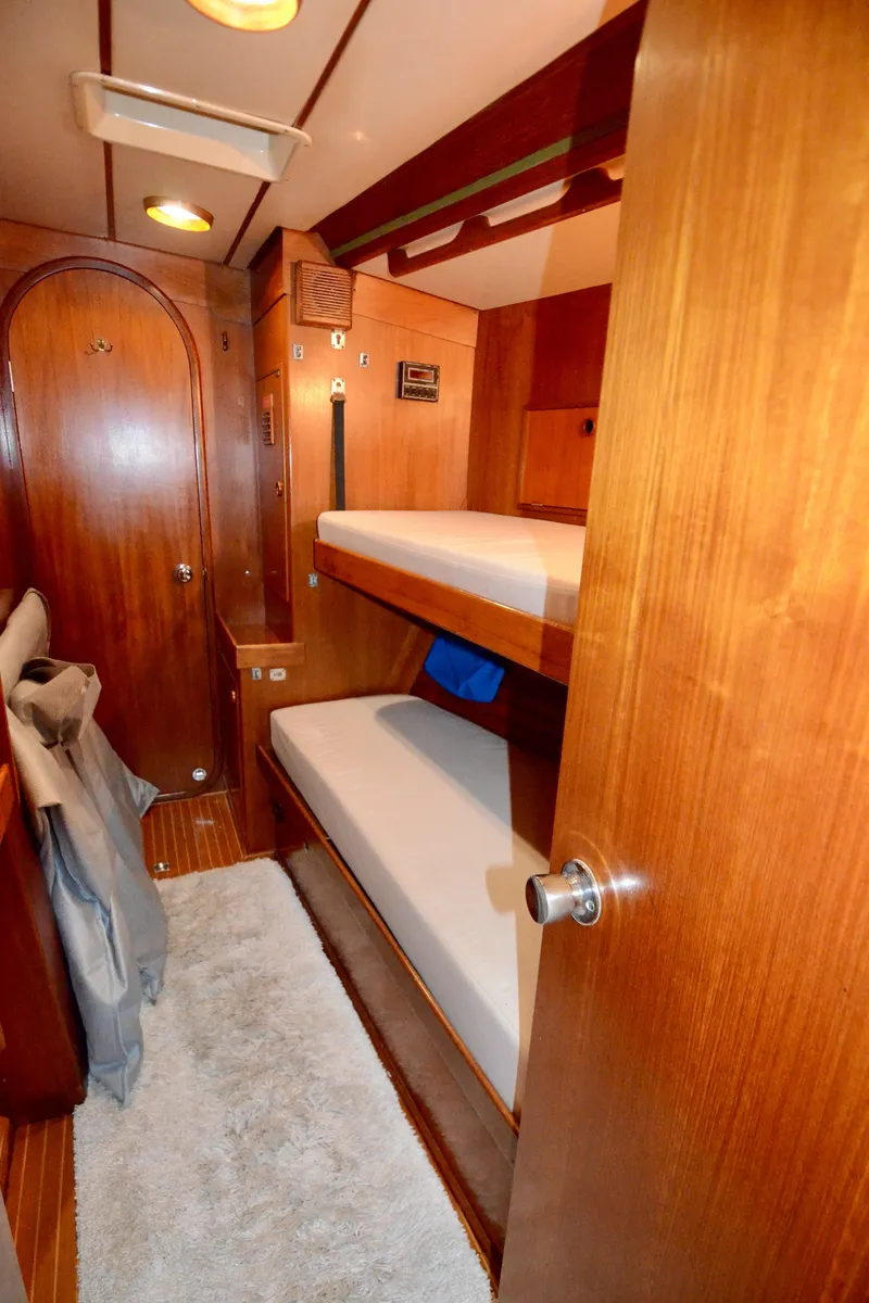 Slide: The Image of Interior of 1983 Nautor Swan 651 yacht with wooden bunk beds and cozy cabin design. - 34