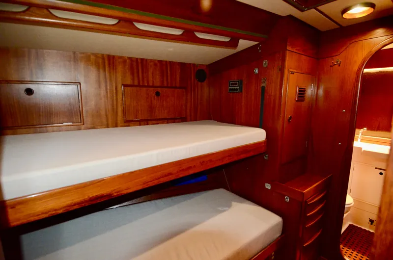 Slide: The Image of Interior of 1983 Nautor Swan 651 yacht with wooden bunk beds and storage. - 37