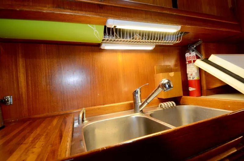 Slide: The Image of Wooden kitchen interior with double sink and faucet on a 1983 Nautor Swan 651 yacht. - 42