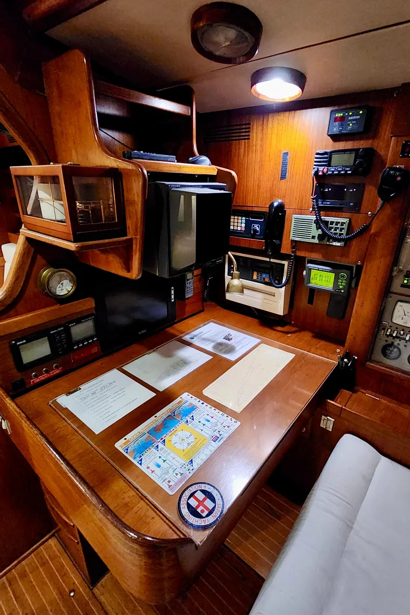 Slide: The Image of Navigation station of 1983 Nautor Swan 651 yacht with wooden interior and equipment. - 44