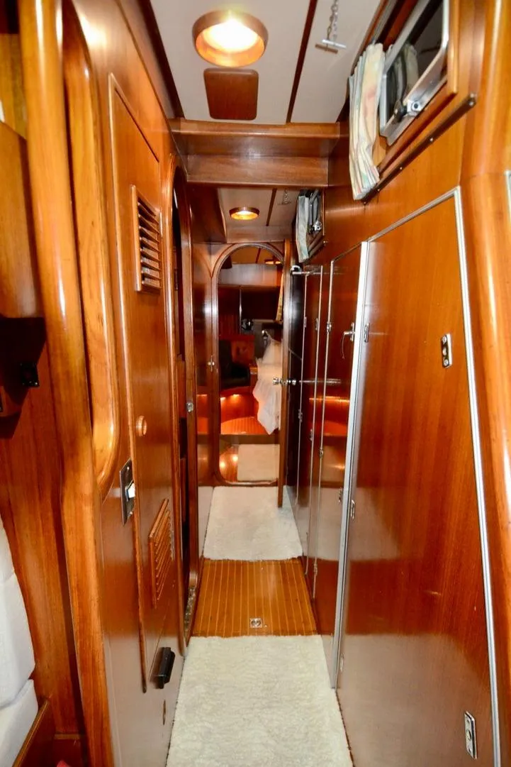 Slide: The Image of Interior of 1983 Nautor Swan 651 yacht with wooden paneling and cozy lighting. - 48