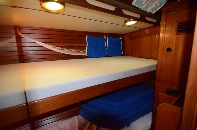 Slide: The Image of Cozy cabin interior of 1983 Nautor Swan 651 yacht with wooden finish and bunk beds. - 49