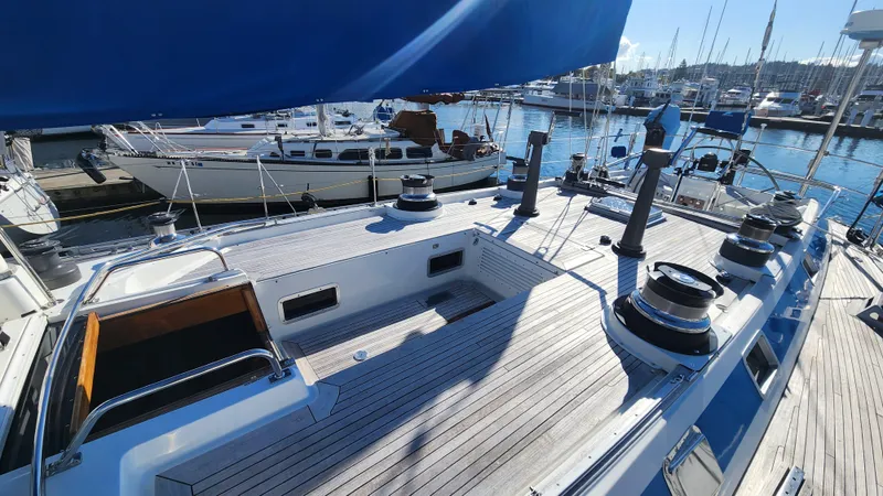 Slide: The Image of 1983 Nautor Swan 651 yacht deck with winches, docked in a marina. - 9