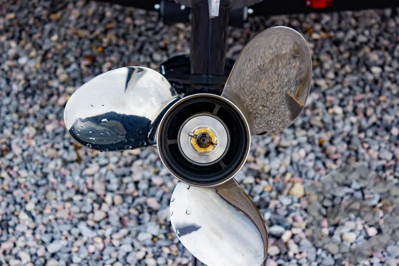 Slide: The Image of Close-up of a shiny boat propeller on gravel, G3 Sportsman 1810, 2025 model. - 12