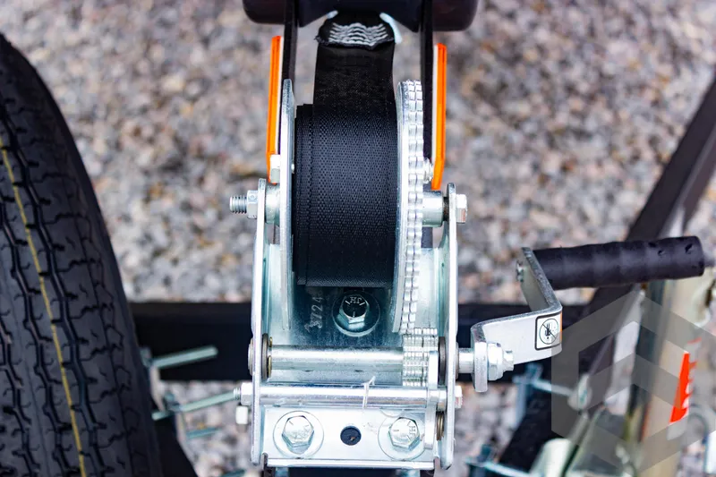 Slide: The Image of Close-up of a 2025 G3 Sportsman 1810 trailer winch and tire on gravel. - 15